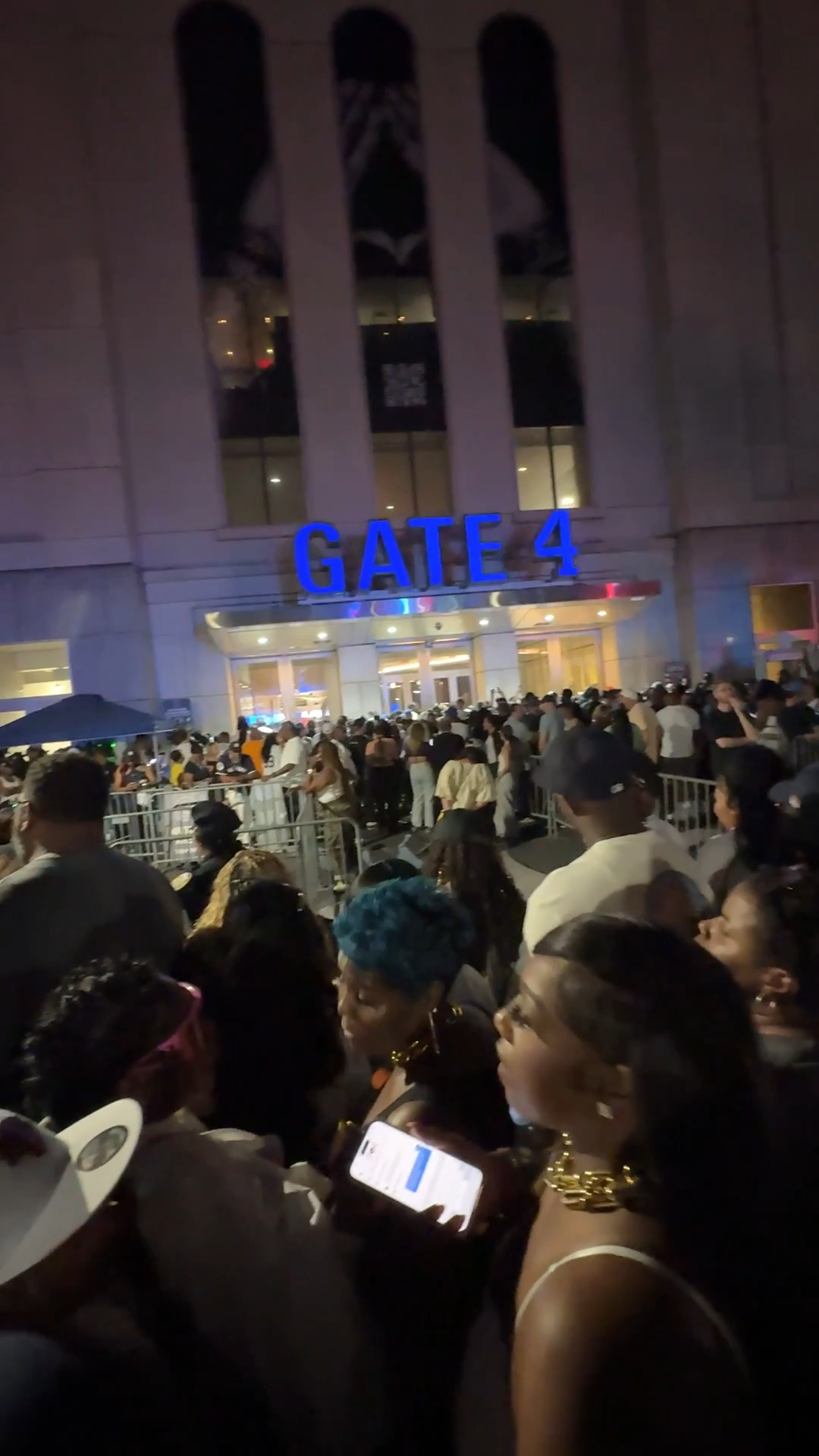 Large crowd of people gathered outside Gate 4 of Yankee Stadium for a Jay-Z concert.