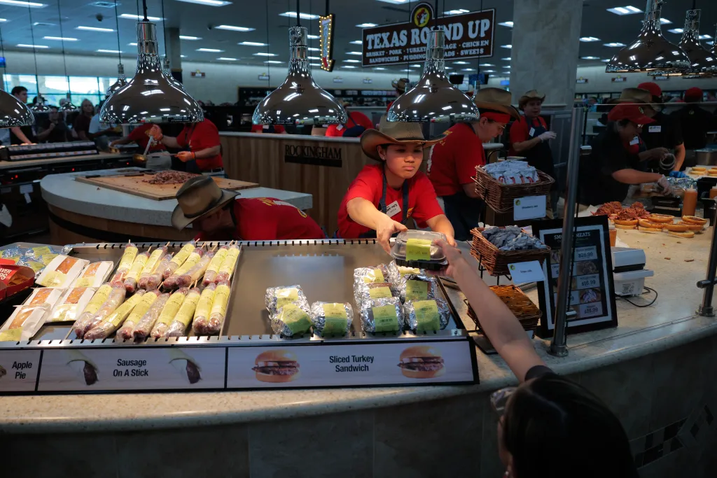 A Buc-ee's employee in a cowboy hat sells freshly made Texas-style barbecue at the first East Coast location.