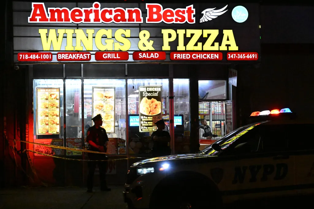 NYPD officers at the scene of a shooting outside American Best Wings & Pizza in Brooklyn, New York.
