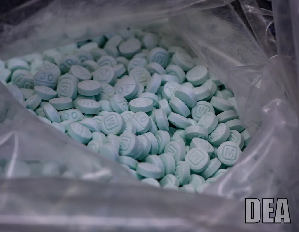 A bulk spill of fentanyl and oxycodone 30mg pills is pictured on Tuesday, April 13, 2021.