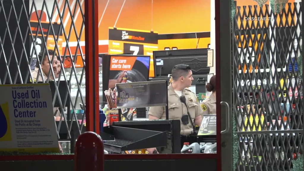 Sheriff's deputies inside a ransacked AutoZone store in East Los Angeles after a street takeover.