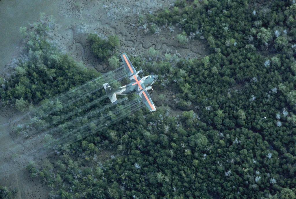 USAF UC-123K plane spraying herbicide over a delta area.