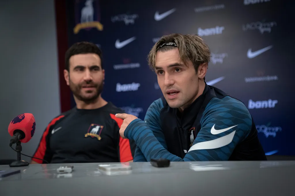 Jamie Tartt and Roy Kent at a press conference.