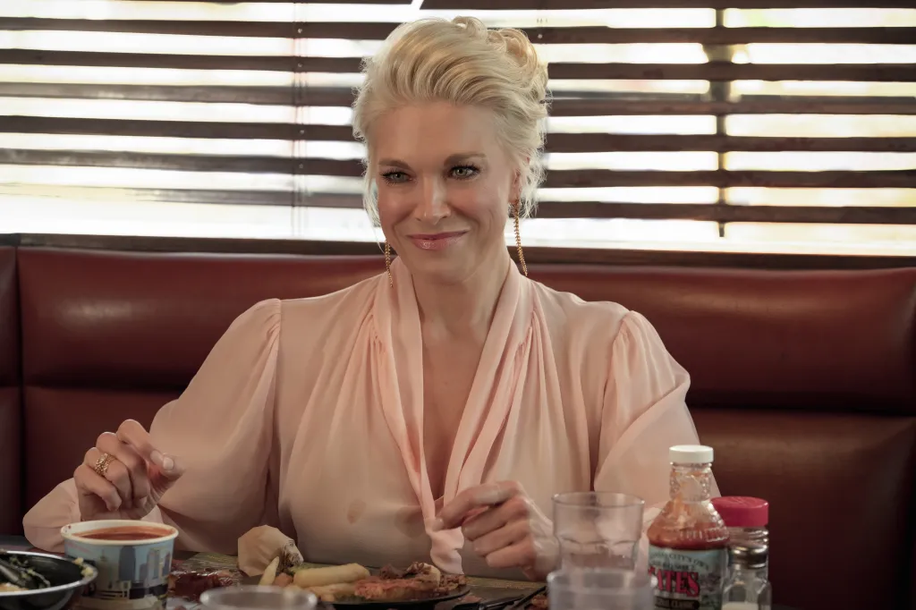 Rebecca Welton sitting in a diner booth.