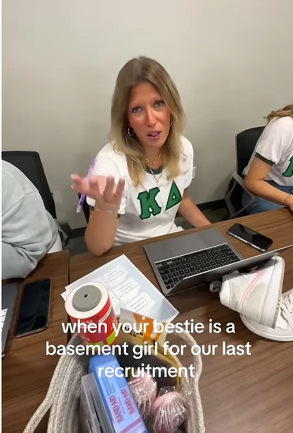 A woman in a white and green shirt with the letters 