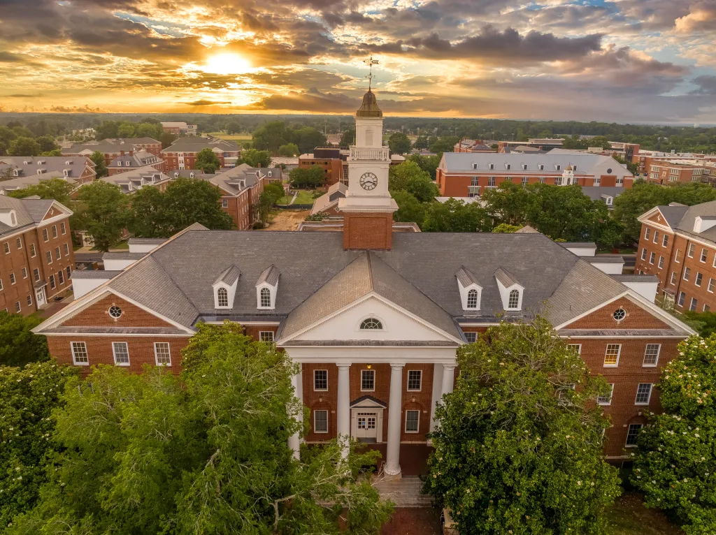 Aerial view of Virginia Hall at Virginia State University under a colorful sunset sky.