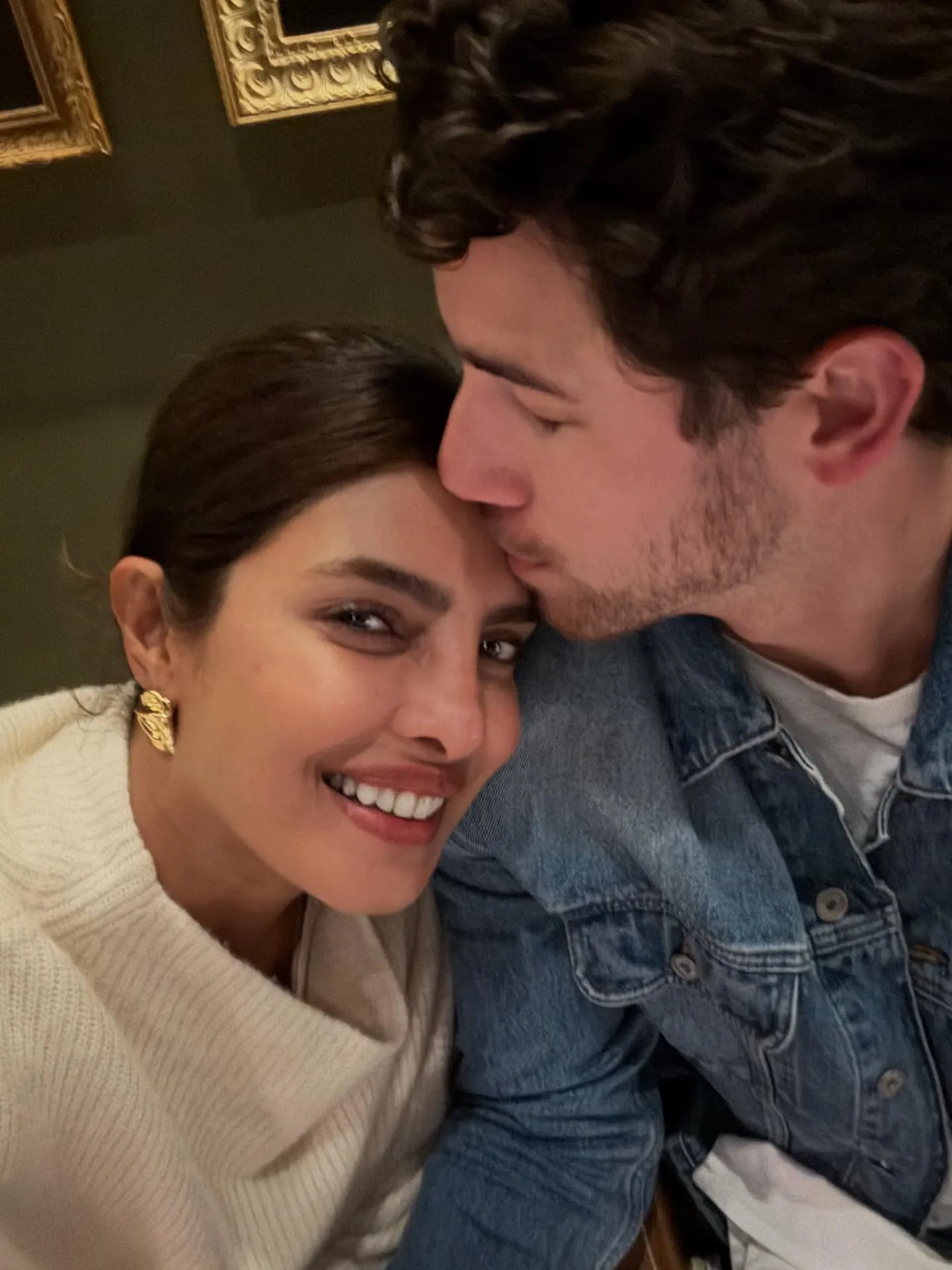 Nick Jonas kissing Priyanka Chopra's forehead.