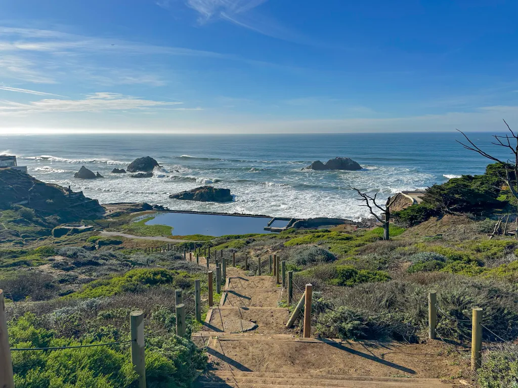 View of Sutro Baths and Lands End from a hiking trail on a sunny winter day in San Francisco.