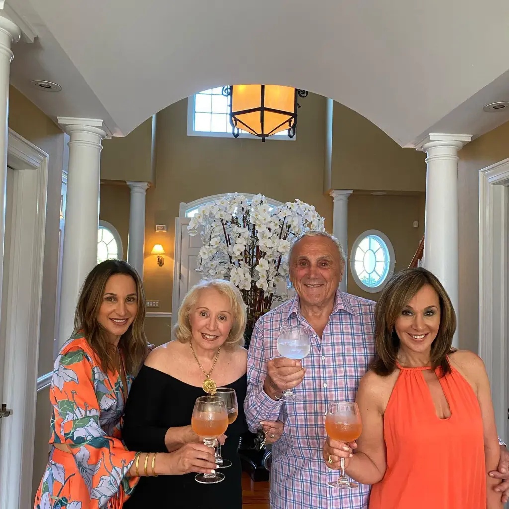 Rosanna Scotto, her sister Eliana, and mother Marion with a man, all holding drinks.
