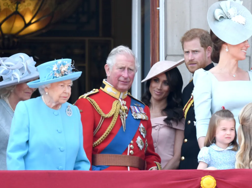 Queen Elizabeth II, Prince Charles, Meghan, Duchess of Sussex, Prince Harry, Catherine, Duchess of Cambridge, and Princess Charlotte on the Buckingham Palace balcony during Trooping The Colour 2018.
