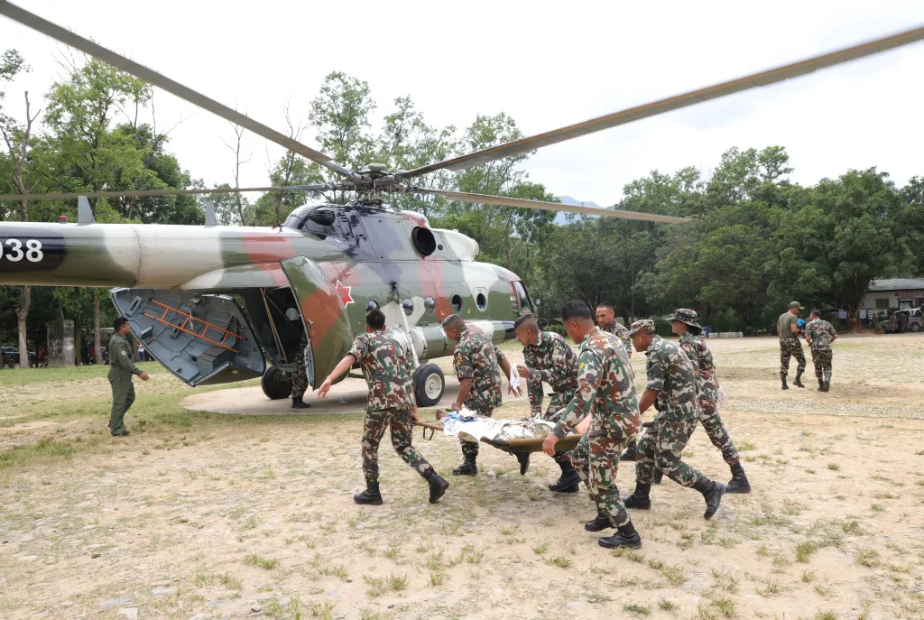 Nepalese Army officers conducting a helicopter rescue of survivors following a flash flood in Trishuli Bazar.