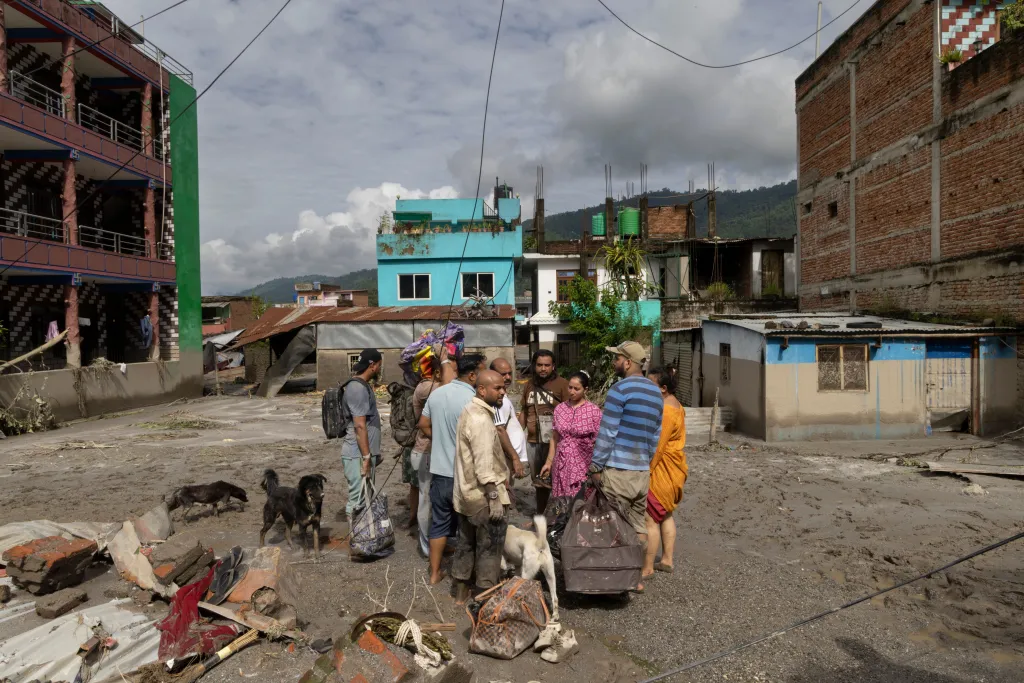 Flood survivors return home on Thursday, in Devighat Village, Nuwakot district, Nepal.