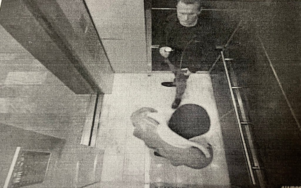 Two men in a Millennium Tower elevator, seen from above.