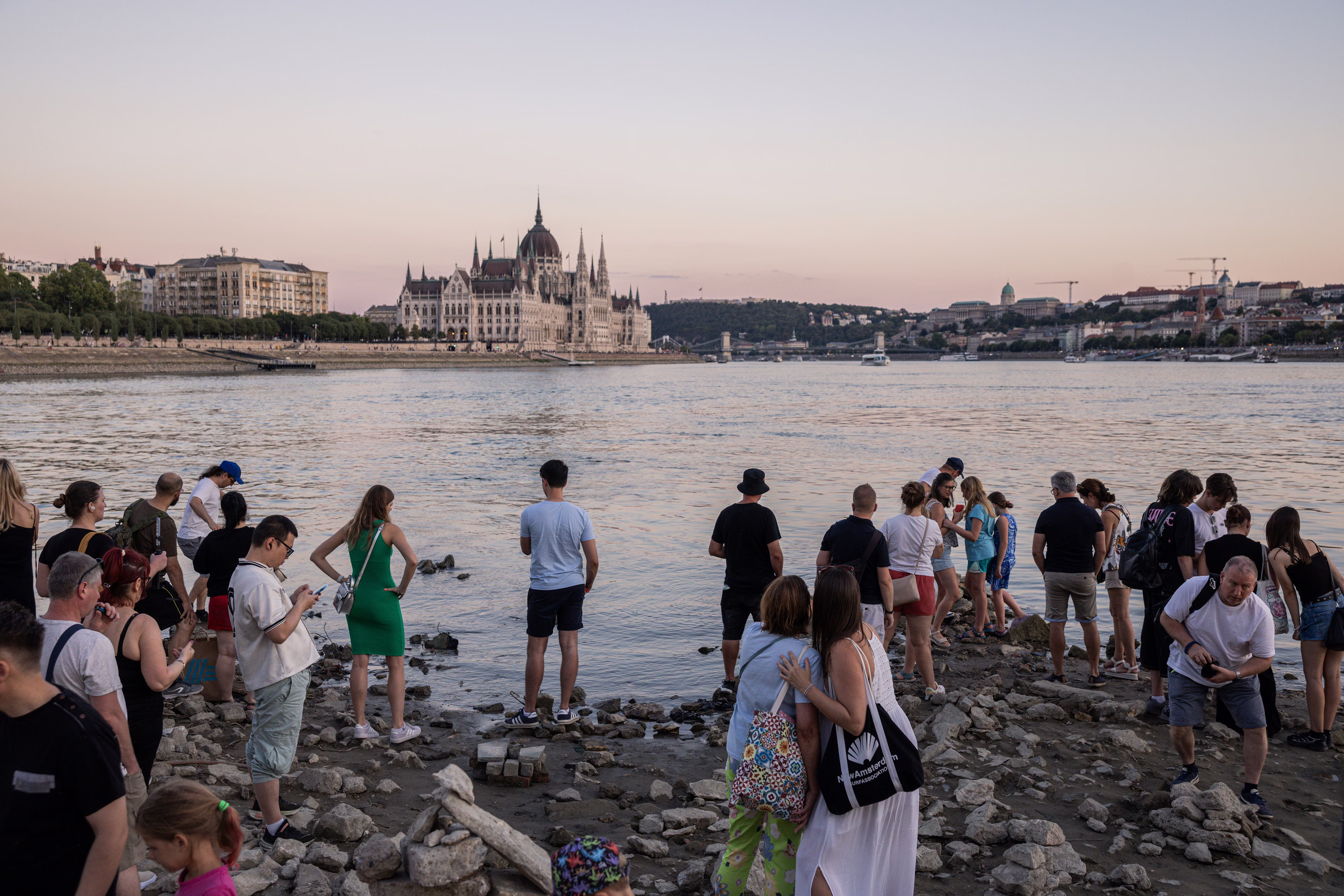 Visitors gather on an exposed section of riverbed during a heatwave in Budapest.