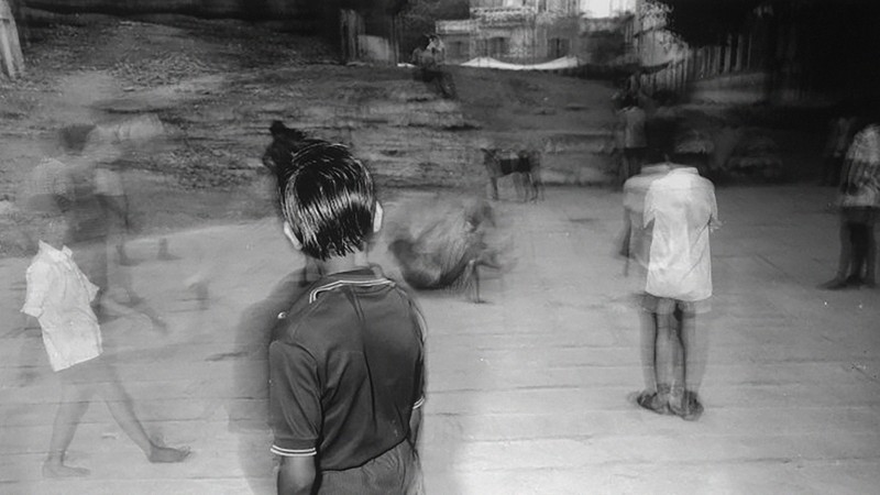 A blurry black-and-white photo of kids outside