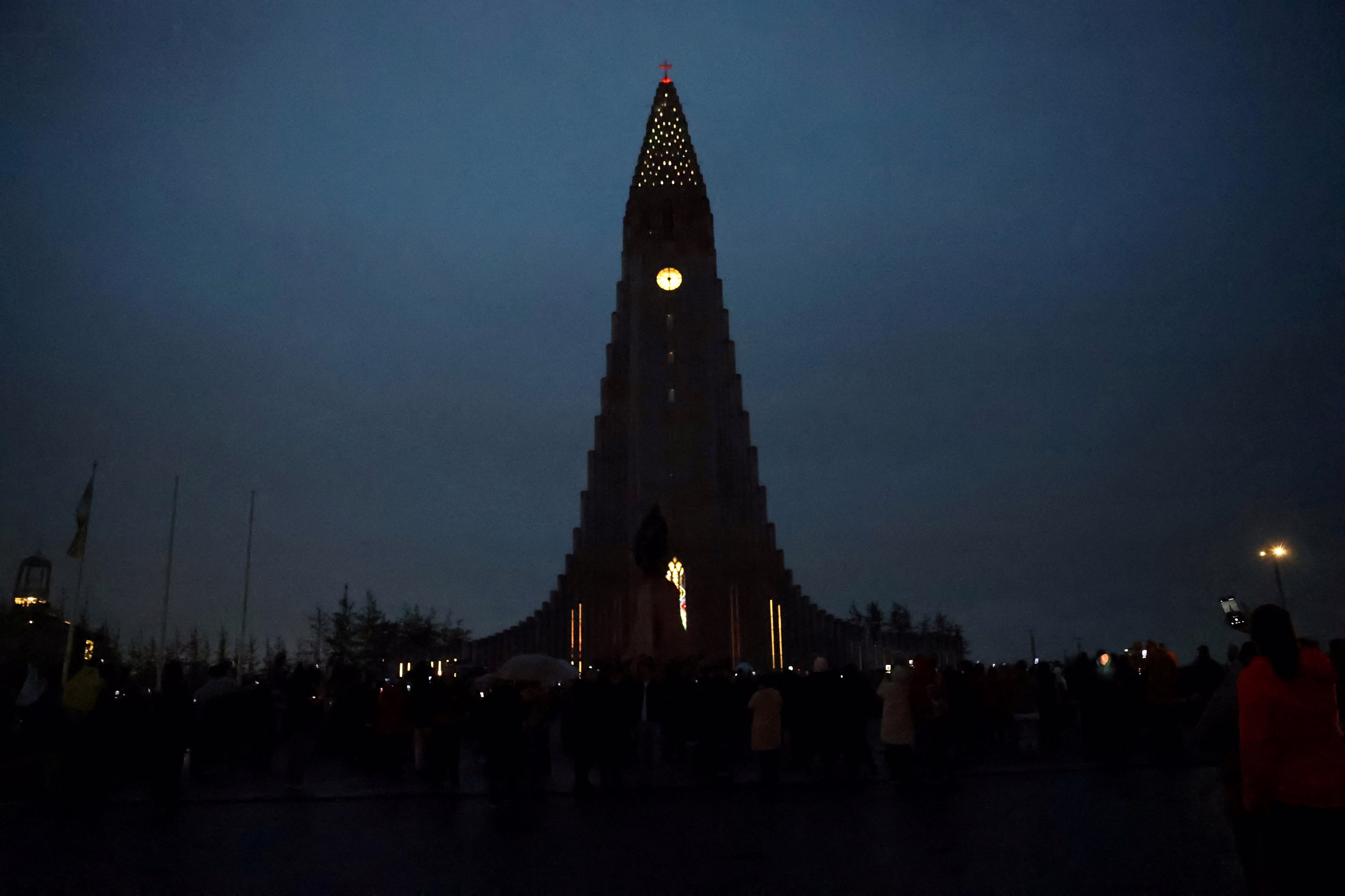 A famous church tower in Iceland, seen under a dark, cloudy sky