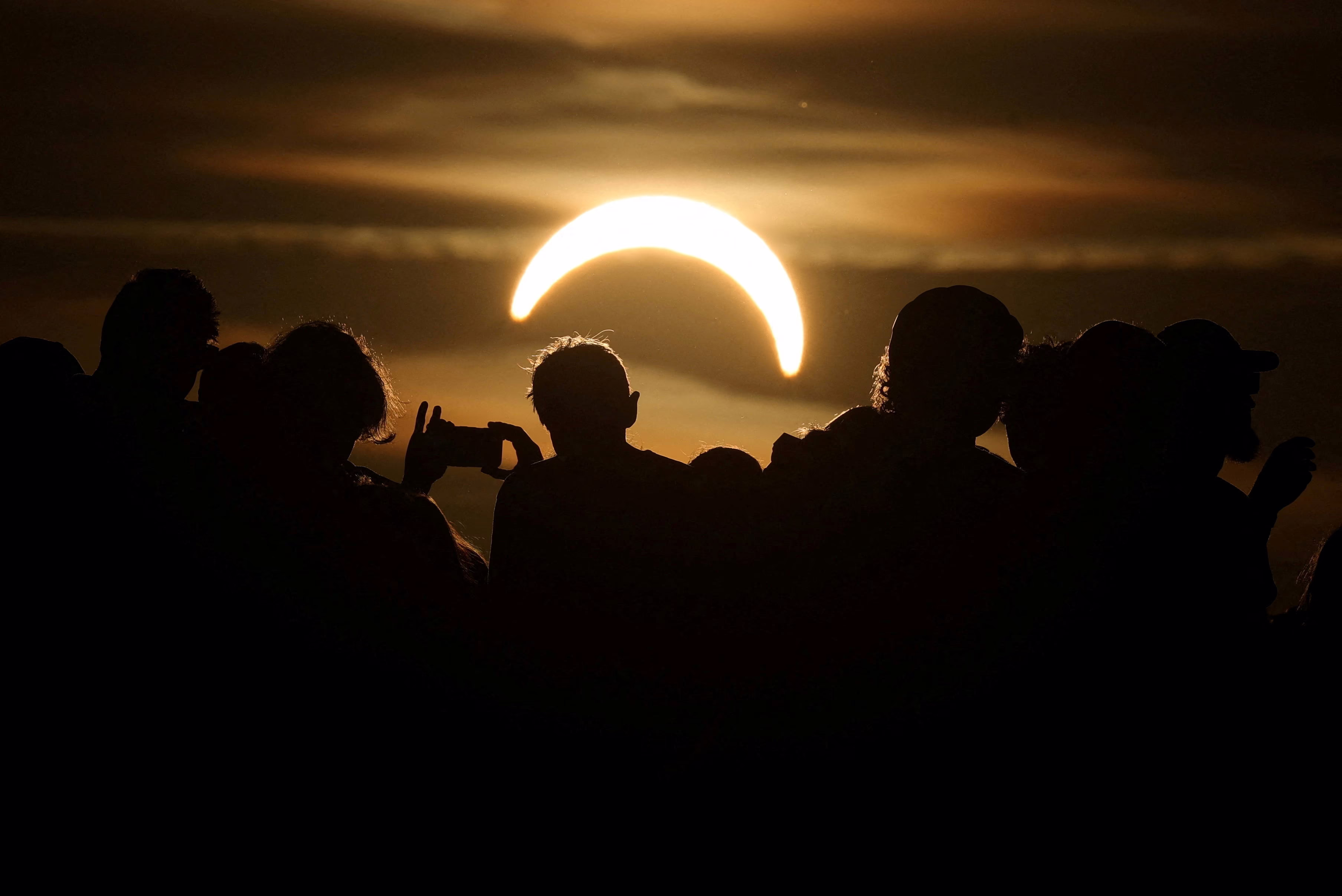 People watch a partial eclipse.