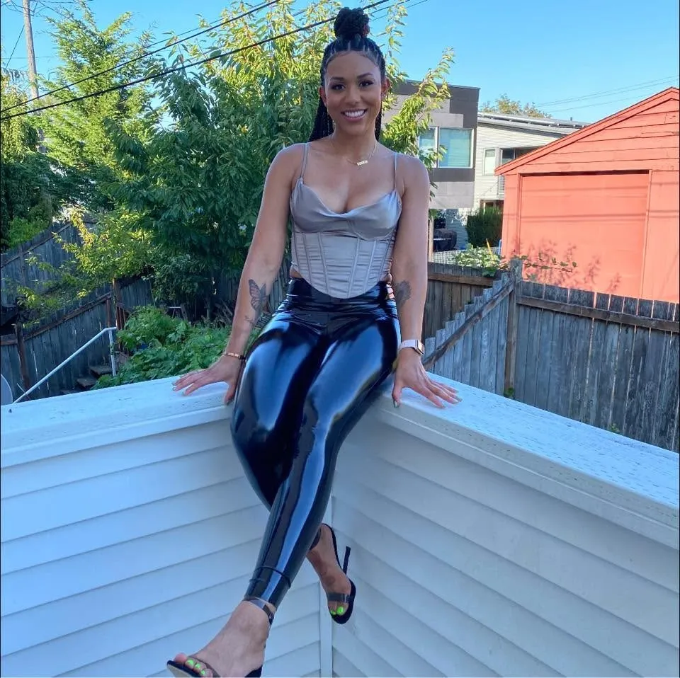 McKenna West sitting on a white fence.