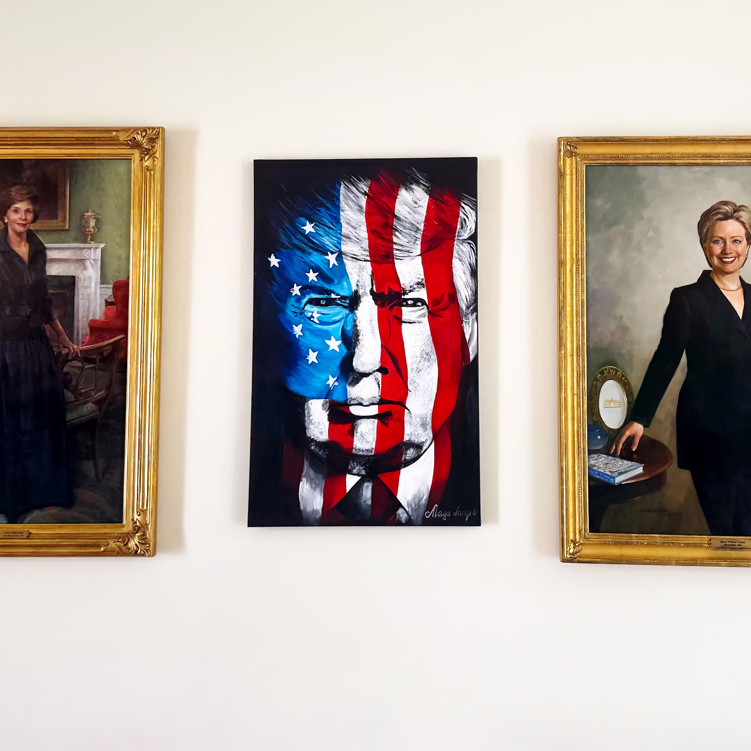 a painting of donald trump between paintings of first Lady Laura Bush and Hilary Clinton