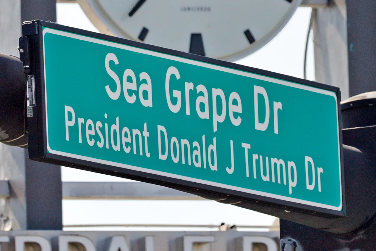 A street sign at Sea Grape Drive and Donald J Trump Drive