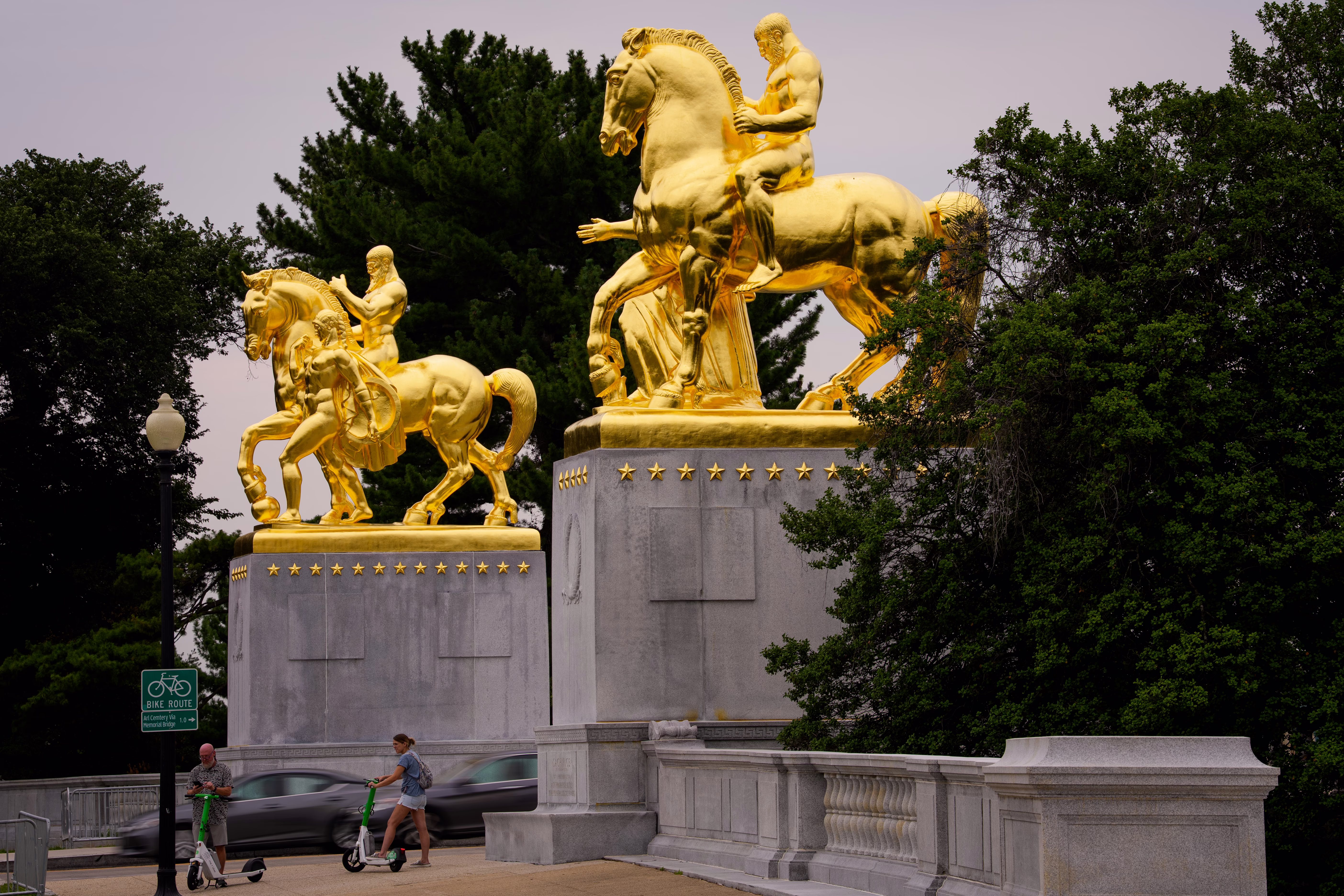 A pair of gold-covered equestrian statues on a bridge in Washington, D.C.