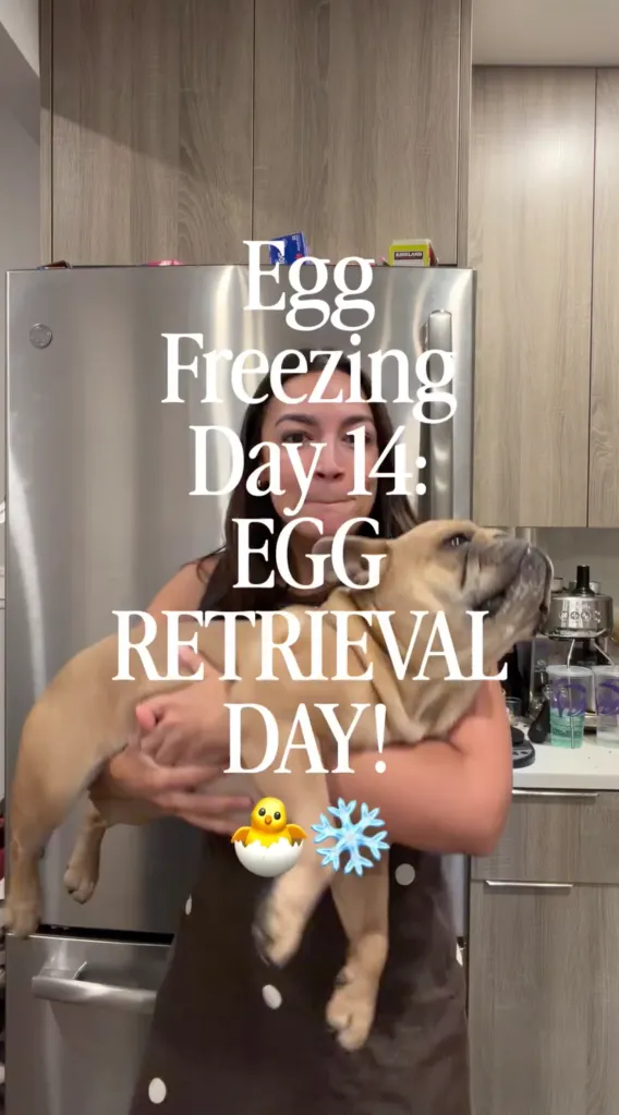 A woman holding a light brown dog in front of kitchen cabinets and a refrigerator. Text overlay says, 
