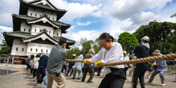 A City Unites Around a Common Goal: Moving a Castle by Hand