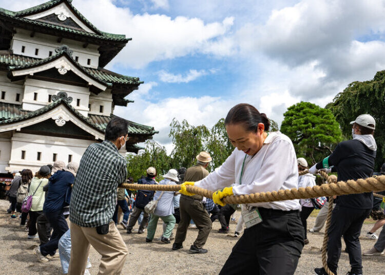 A City Unites Around a Common Goal: Moving a Castle by Hand