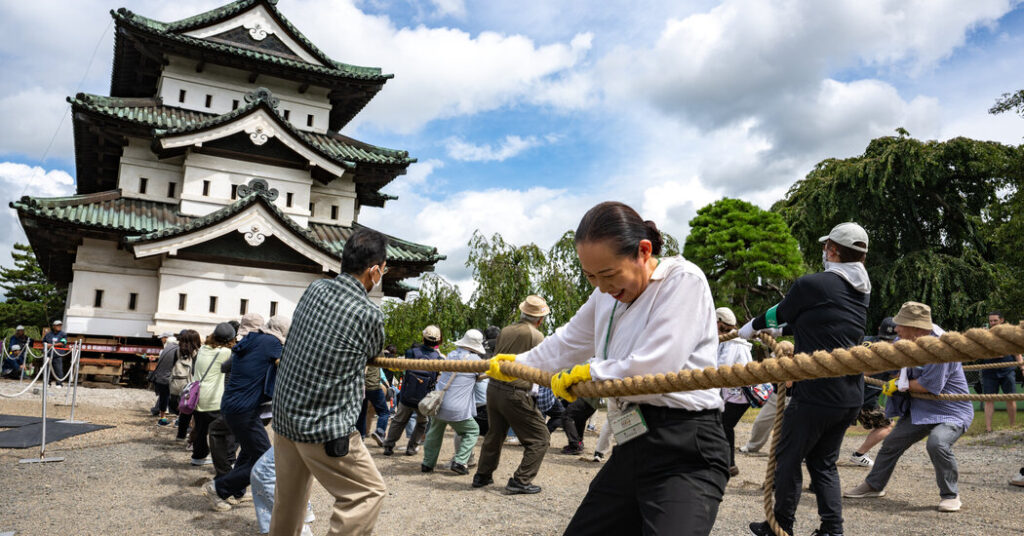 A City Unites Around a Common Goal: Moving a Castle by Hand