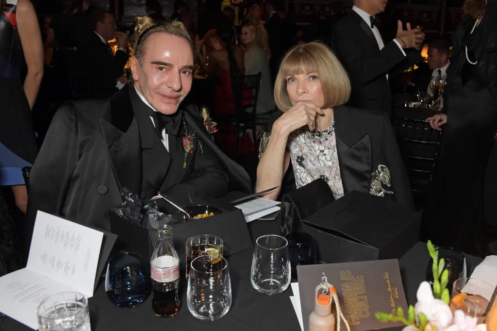 John Galliano and Anna Wintour at a cocktail reception.
