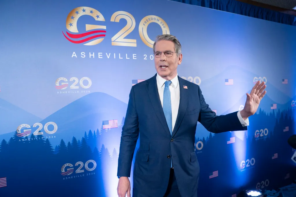 US Secretary of Treasury Scott Bessent speaking to reporters in front of a G20 backdrop.