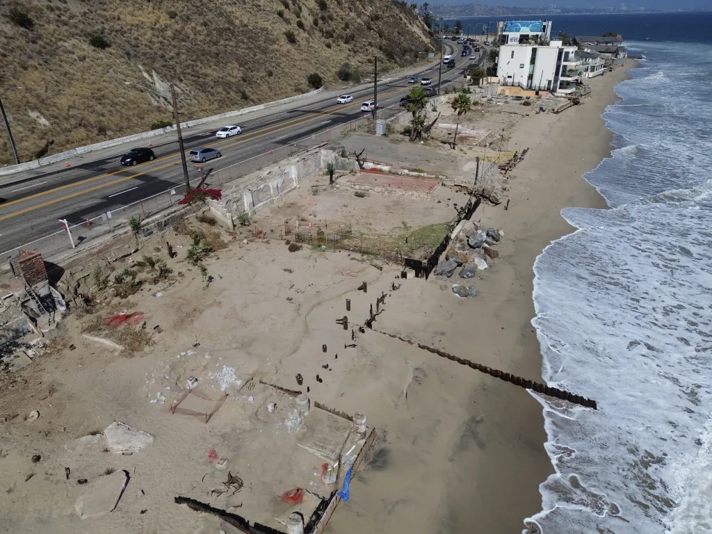 Aerial view of properties destroyed by the 2025 LA wildfires along the Malibu coastline.