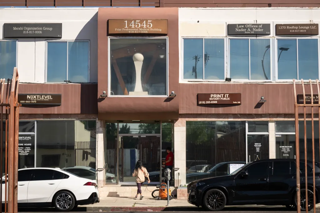 A person entering the Merabi Professional Medical Plaza Building in Van Nuys, which is registered as the address for 197 hospices.
