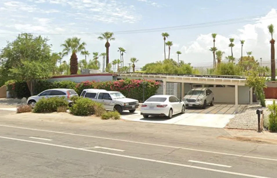 View of the property at 1979 E Alejo Rd, Palm Springs, CA 92262, showing the front of the house and driveway.