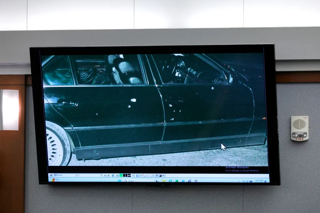 A photo of the bullet-riddled car Tupac Shakur was riding in during his shooting, displayed on a TV screen during a murder trial.