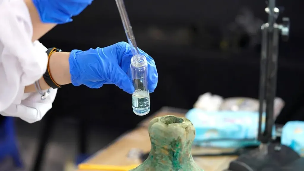 Researcher analyzes Bronze vessel.