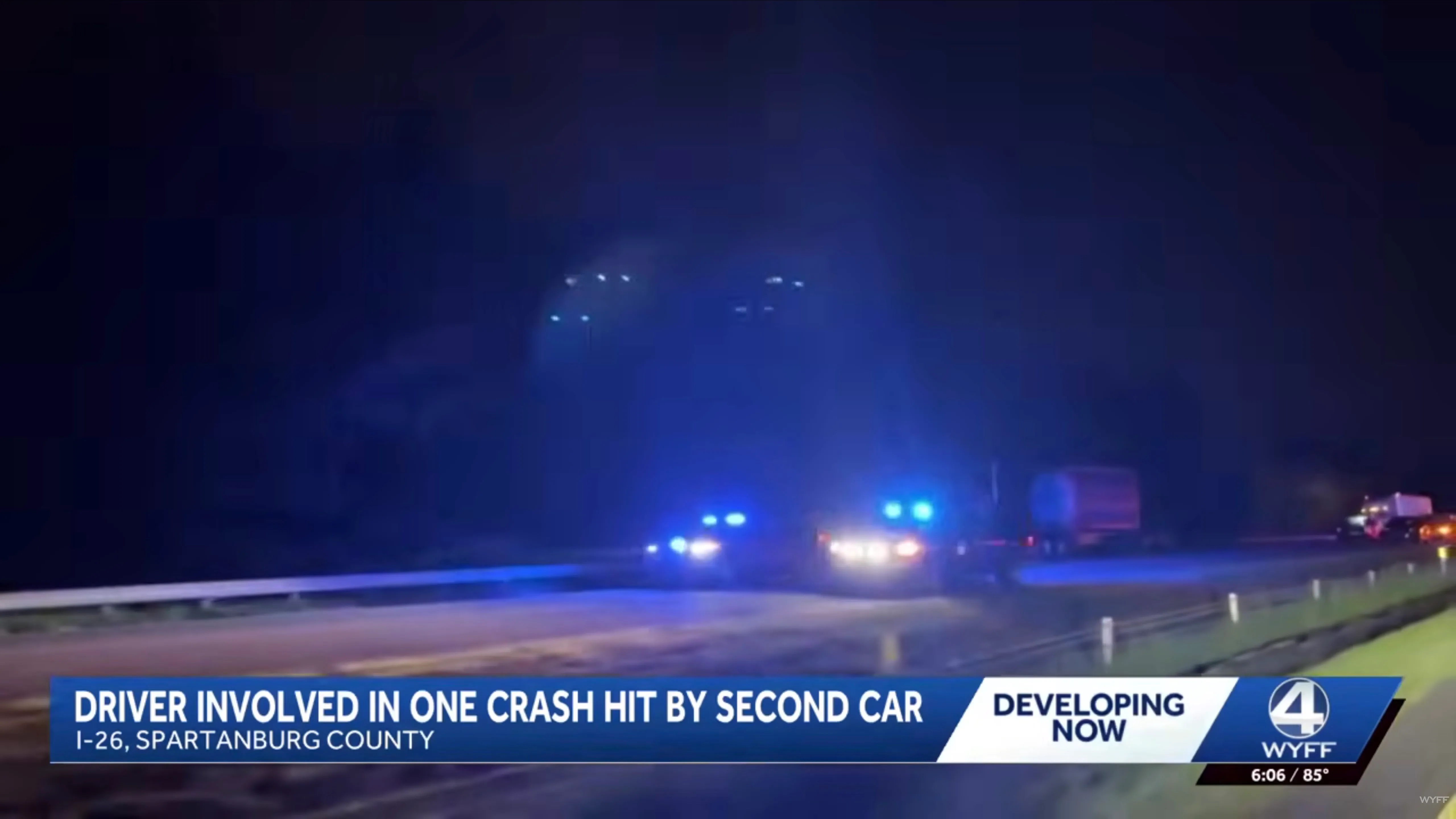 A nighttime photo of a highway accident with police lights, featuring news graphics at the bottom about a driver involved in a second crash.
