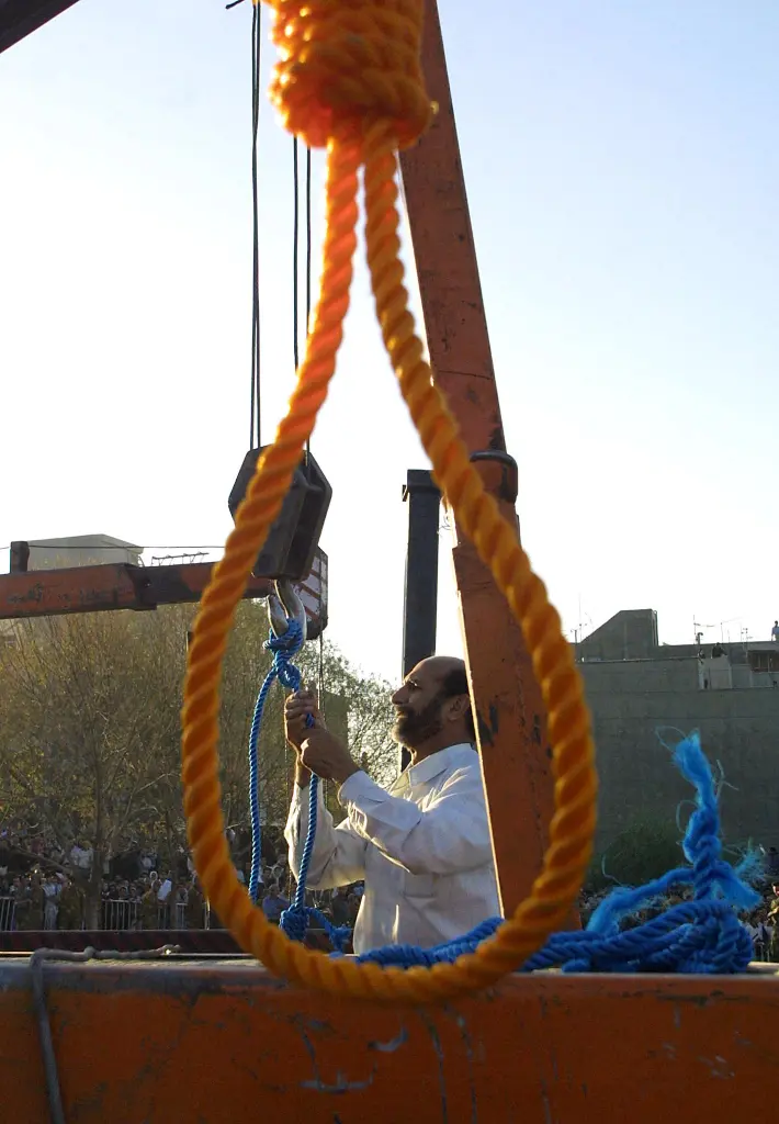 An Iranian judiciary staff member tying ropes for an execution by hanging.