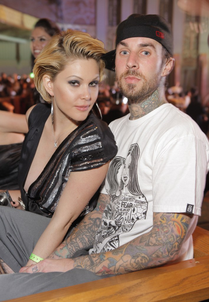 Travis Barker and Shanna Moakler posing for a photo.