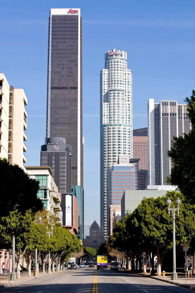 The AON Center building and U.S. Bank Tower stand along the skyline of Los Angeles.