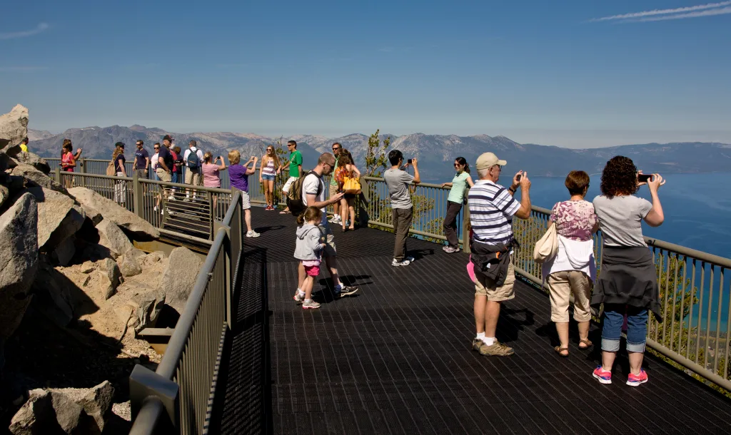 Visitors take pictures from the observation deck at Heavenly Ski Resort in South Lake Tahoe, California.