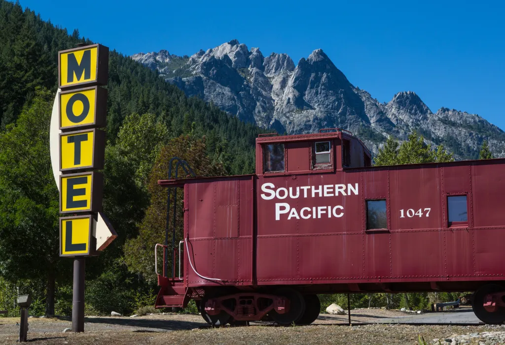 A red Southern Pacific caboose and yellow 