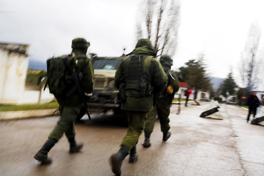 Armed soldiers without identifying insignia keep guard outside of a Ukrainian military base in the town of Perevevalne near the Crimean city of Simferopol on March 16, 2014 in Perevevalne, Ukraine.