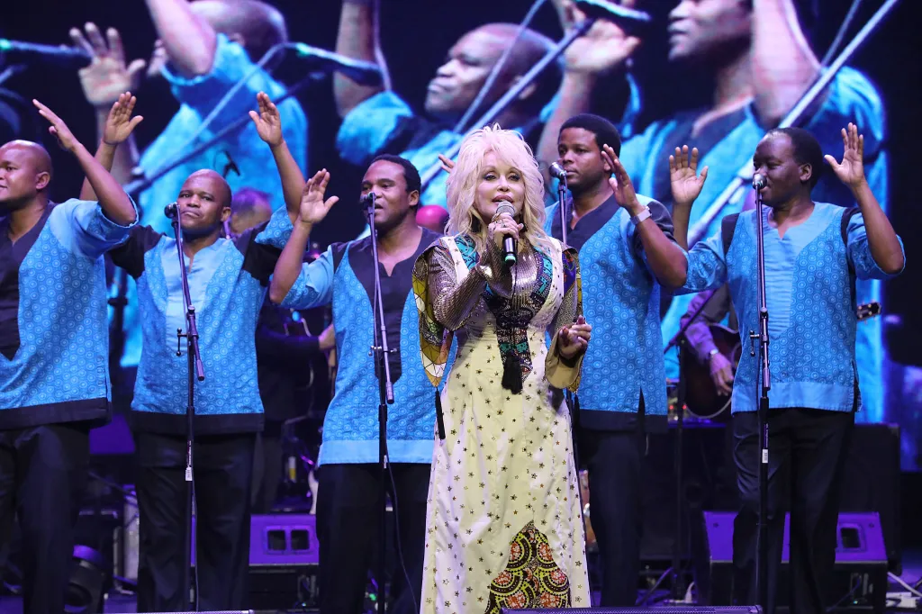 Dolly Parton performing on stage with Ladysmith Black Mambazo.