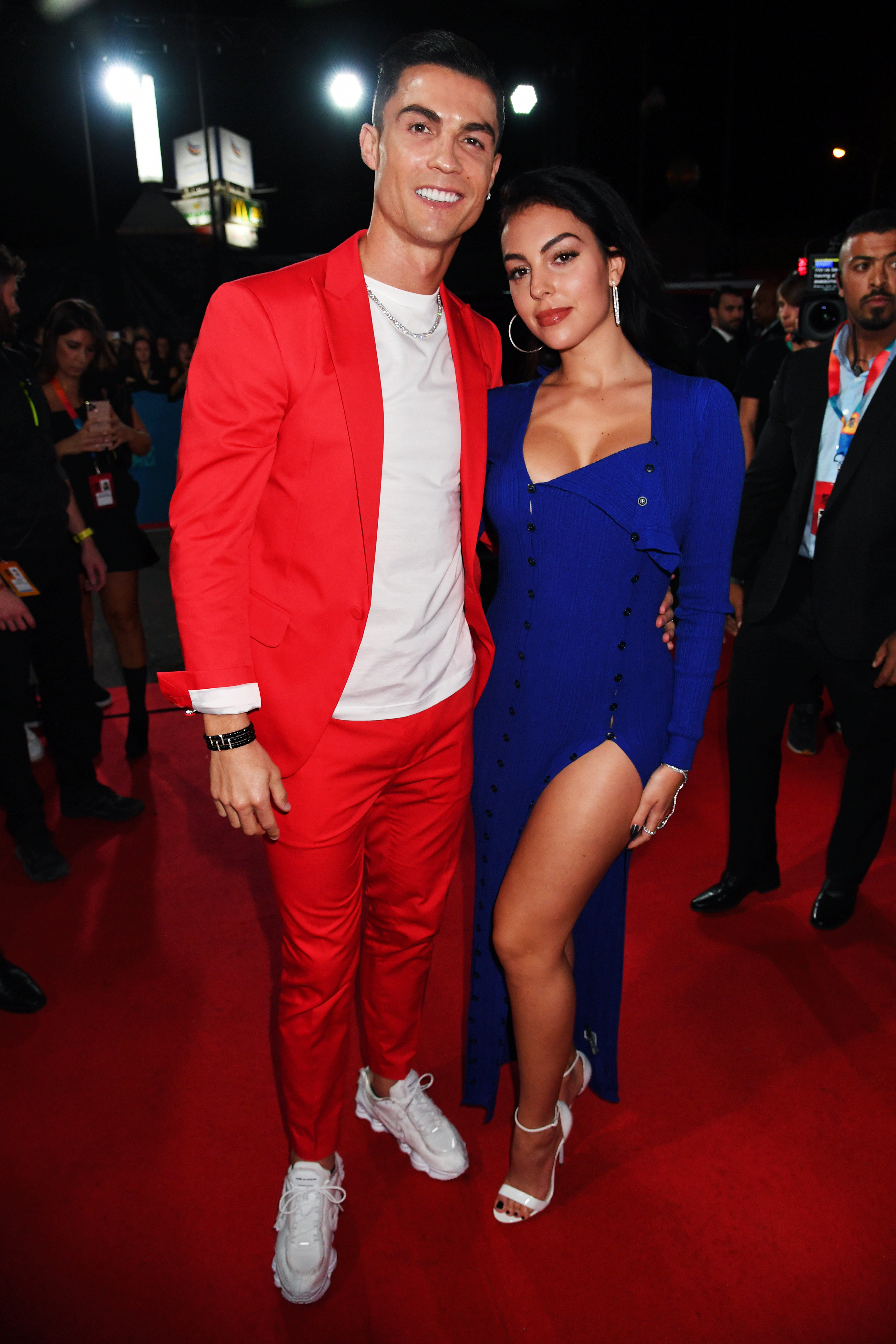 Georgina Rodriguez and Cristiano Ronaldo pose on a red carpet.