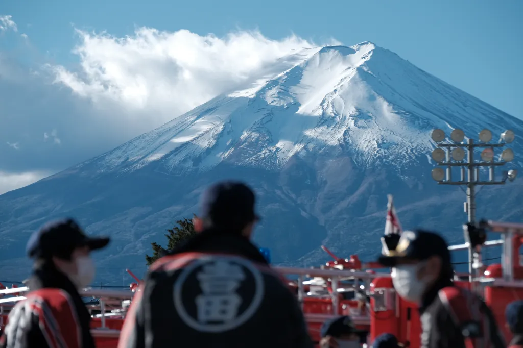 Firefighters participate in an evacuation drill in front of Mount Fuji.