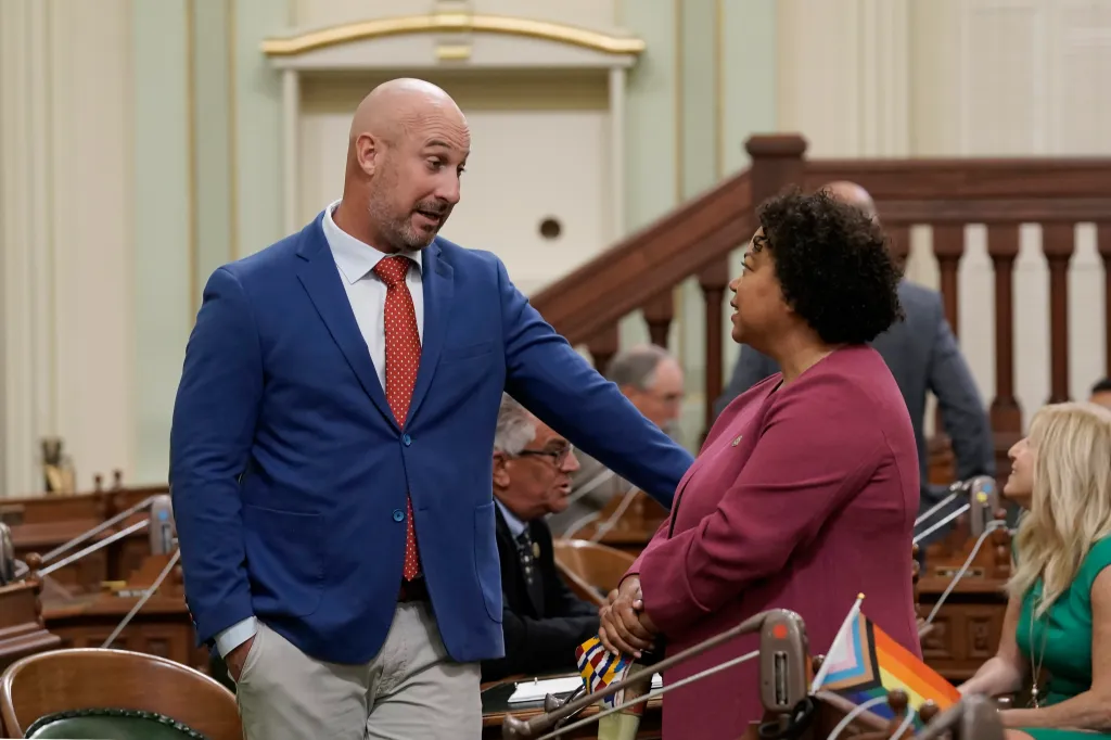 Assemblyman Heath Flora, R-Ripon, talks with Assemblywoman Mia Bonta, D-Oakland, during the Assembly session.