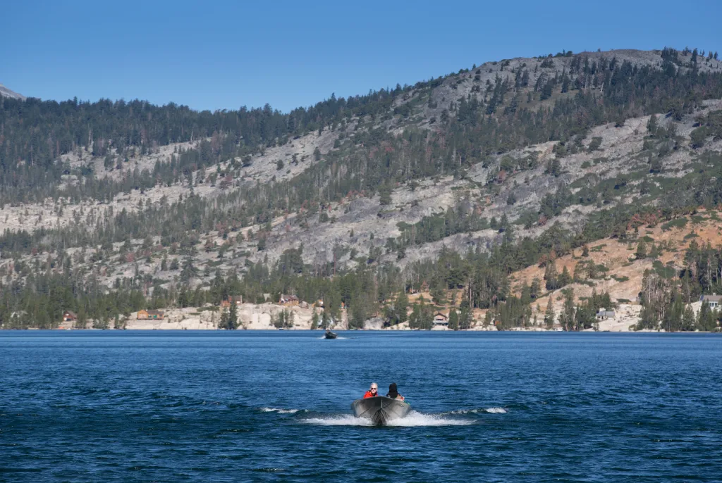 A fisherman powers his boat along Echo Lake near South Lake Tahoe, California.
