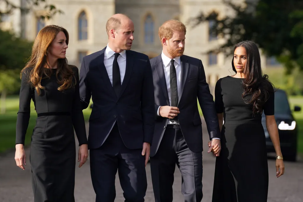Catherine, Princess of Wales, Prince William, Prince of Wales, Prince Harry, Duke of Sussex, and Meghan, Duchess of Sussex, walk along the Long Walk at Windsor Castle.