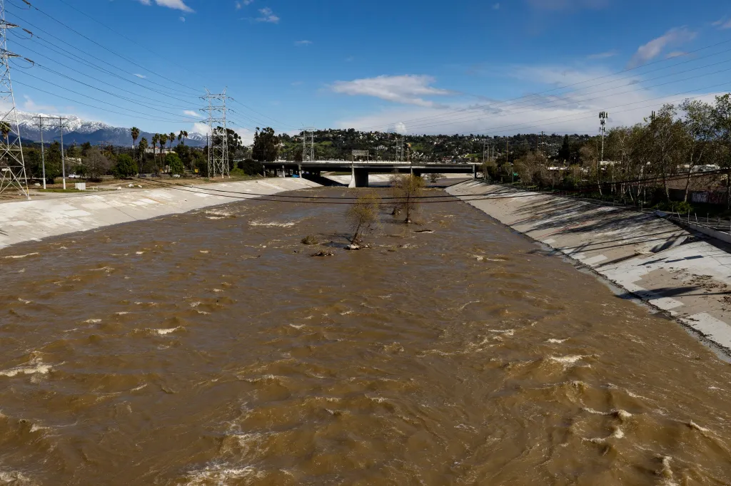 The LA River is full of raging brown water due to record high rains and snow.